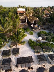 an aerial view of a resort with benches and palm trees at Orchid House Tulum Beach in Tulum