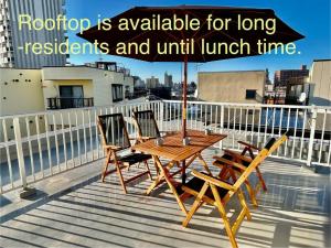 a wooden table and two chairs on a balcony at Private Japanese garden,130m2, Ikebukuro Shinjuku Shibuya 5-15min , 200 restaurants nearby, 7-11 in front in Tokyo