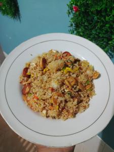 a plate of fried rice on a white plate at Backpackers Homestay in Labuan Bajo +14 photos
