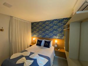 a bedroom with a bed with a blue wall at Sunny Hall - Apto com Piscina Privativa in Porto De Galinhas +17 photos