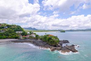 an island in a body of water with houses at Casa De Los Sueños, Brand New Ocean View Home On 125 Acres! in Brasilito