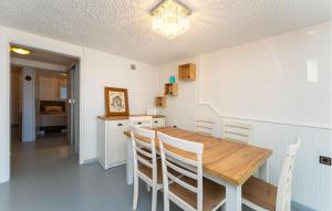 a kitchen with a wooden table and chairs at 2 Bedroom Awesome Apartment In Rtina in Rtina