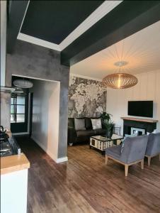 a living room with a couch and a tv at What’s behind the green door! in Cape Town
