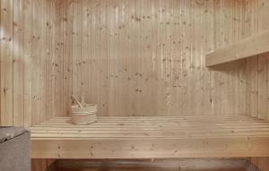a wooden sauna with a bucket on a wooden platform at Holiday Home Snedsted 59 in Stenbjerg +15 photos