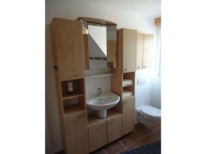 a bathroom with a sink and a toilet at Alter Badweg Holiday Apartment 4 in Sankt Peter-Ording