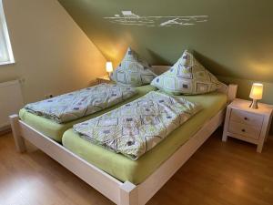 a bedroom with two beds with pillows on it at Alter Badweg Holiday Apartment 4 in Sankt Peter-Ording