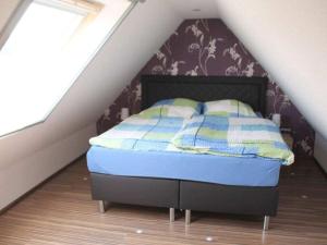 a bedroom with a bed in a attic at Wehner Comfortable holiday residence in Marl