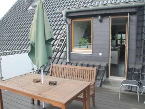 a patio table with an umbrella on a house at Wehner Comfortable holiday residence in Marl