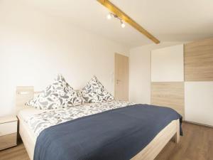 a bedroom with a large bed with pillows on it at 1 - Eilrich Comfortable holiday residence in Thiessow