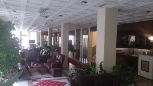 a living room with couches and chairs in a building at Hotel Villa Tasko in Drama