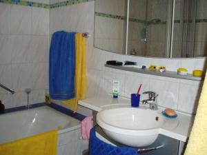 a bathroom with a sink and a bath tub and a sink at Ferienhof Mayer - Apartment 4 in Lautenbach