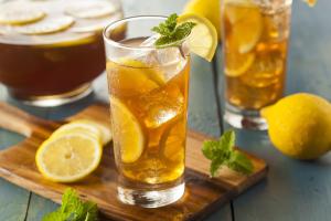 a glass of lemonade with lemon slices and mint at My Studio Hotel Losari Makassar in Makassar