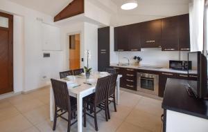 a kitchen with a table and chairs in a kitchen at Casa Morgana in Scilla
