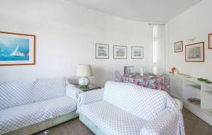 a living room with two chairs and a couch at 2 Bedroom Awesome Apartment In Rapallo in Rapallo