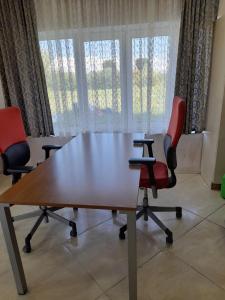 a conference room with a table and two chairs at Argo rooms in Berehove