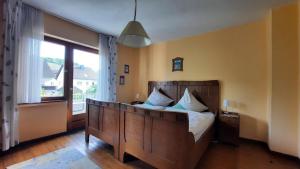 Un dormitorio con una cama grande y una ventana grande. en Ferienwohnung Maria Magdalena, en Bad Neuenahr-Ahrweiler