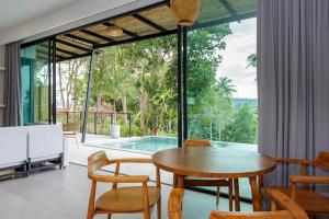a dining room with a table and chairs and a pool at 2br Seaview pool villa B in Hinkong