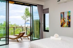 a bedroom with a bed and a balcony at 2br Seaview pool villa B in Hinkong