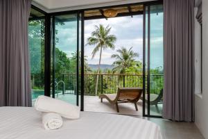 a bedroom with a bed and a view of a balcony at 2br Seaview pool villa B in Hinkong