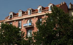 a building with a hotel sign on the side of it at Hotel le Dauphin in Ajaccio