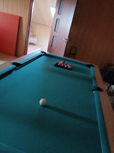 a pool table with a ball on top of it at Pensiune Colina Farm in Găgeni