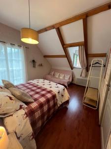 a bedroom with two beds in a attic at Villa Coustete in Bôo-Silhen +5 photos