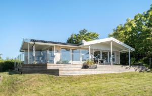 a house on a hill with glass at Fyrrehuset in Helnæs By +5 photos