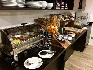 a kitchen with a counter with food on it at Brit Hotel Martigues Nord in Martigues
