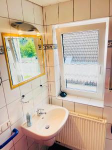 a bathroom with a sink and a mirror at Ferienwohnungen Klaß in Alken