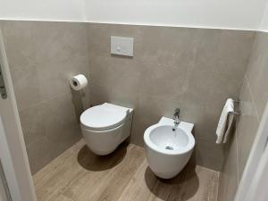 a bathroom with a toilet and a sink at Appartamento Sole in Numana +19 photos