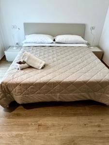 a large bed in a bedroom with two night stands at Appartamento Sole in Numana