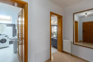 a bathroom with a washing machine and a mirror at Apartments Bellissima in Funtana +103 photos