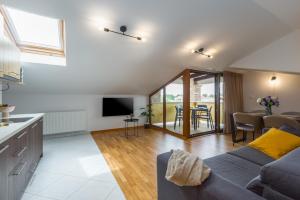 a living room with a couch and a table at Apartments Bellissima in Funtana