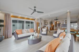 a living room with couches and a dining room at The Compound - Villa 3 in Baie du Tombeau +28 photos
