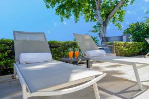 two chairs sitting next to each other on a patio at The Compound - Villa 3 in Baie du Tombeau