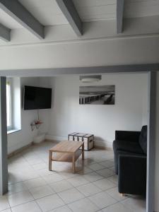 a living room with a couch and a coffee table at le petit hameau in Fontenay-sur-Mer