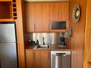 a small kitchen with a sink and a refrigerator at Casa Reina in Playa Jandia