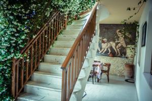 a staircase in a house with ivy at Erifili Kallithea in Kallithea Halkidikis