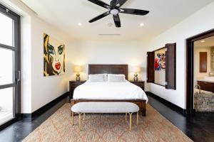 a bedroom with a bed and a ceiling fan at Condo La Perla 163, Ocean View 3 Bedroom Penthouse in Tamarindo