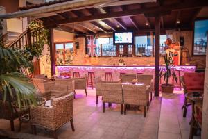 a restaurant with tables and chairs and a bar at Erifili Kallithea in Kallithea Halkidikis