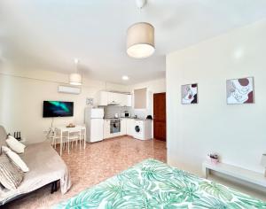 a living room with a bed and a kitchen at SUN JULZ - Eden complex Sea View Studio in Chlorakas