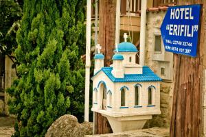 a model of a church in front of a building at Erifili Kallithea in Kallithea Halkidikis