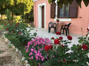 a patio with flowers and a table and chairs at Ηρεμία - Φύση in Kastanéa