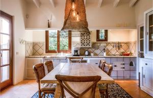 a kitchen with a large wooden table and chairs at Lovely Home In Porto Cristo in Porto Cristo