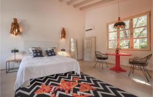 a bedroom with a bed and a table and chairs at Lovely Home In Porto Cristo in Porto Cristo