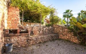 a stone wall with a bench next to a building at Lovely Home In Porto Cristo in Porto Cristo +27 photos