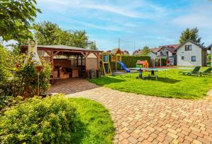 a backyard with a playground and a play structure at Willa Wilk Morski in Jastrzębia Góra