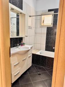 a bathroom with a sink and a bath tub at Vineyard Villa in Himare +23 photos