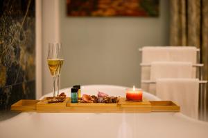 a tray with a candle and a glass of wine at Curcumelli Luxury Suites in Corfu Town
