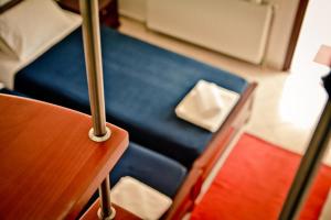 a blue seat on a train with a bed at Erifili Kallithea in Kallithea Halkidikis
